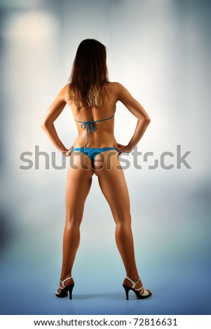 woman beautiful back athletic muscular in swimsuit and heel-strap full length