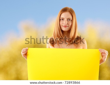 woman holding blank yellow banner over nature background