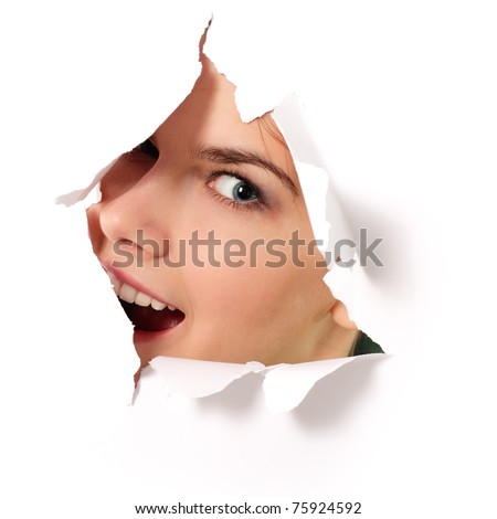 stock photo cheerful teen girl peeping surprised through hole in paper