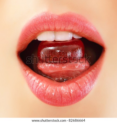 woman sucking cute sweet candy closeup lips teeth tongue