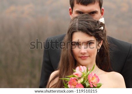 wedding portrait, young groom with bride in love over autumn nature background, park fall outdoor