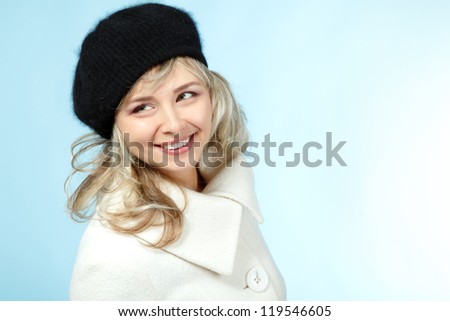 mid adult happy smiling woman winter portrait, attractive caucasian middle aged 40 years old woman in coat and hat over blue
