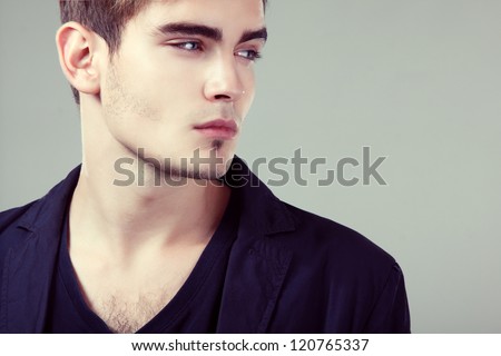 Young man handsome face closeup, sexy guy looking at camera, isolated