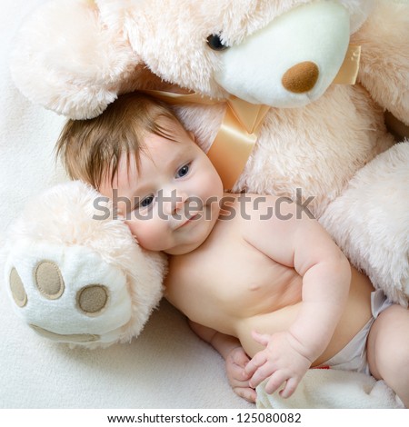 cute funny infant baby boy with big toy bear, beautiful kid\'s portrait closeup