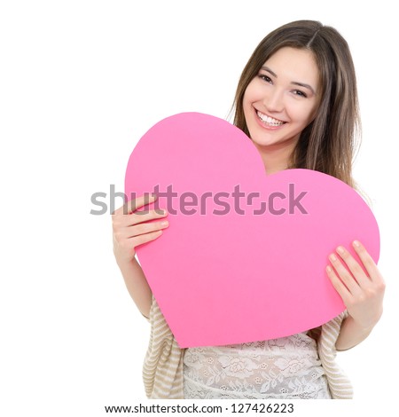 portrait of attractive happy smiling teen girl with pink heart love holiday valentine symbol over white background portrait of attractive happy smiling teen girl with pink heart love holiday valentine symbol over white background