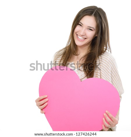portrait of attractive happy smiling teen girl with pink heart love holiday valentine symbol over white background portrait of attractive happy smiling teen girl with pink heart love holiday valentine symbol over white background