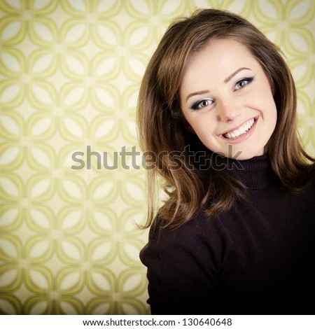 art portrait of young smiling ecstatic woman looking out at camera in room with vintage wallpaper, retro stylization 60-70s, toned