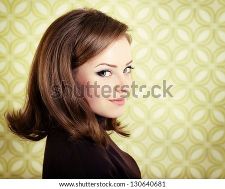 art portrait of young smiling ecstatic woman looking out at camera in room with vintage wallpaper, retro stylization 60-70s, toned