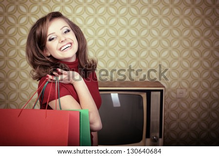 art portrait of young smiling woman and holding shopping sale bags in room with vintage wallpaper, retro stylization 60-70s, toned