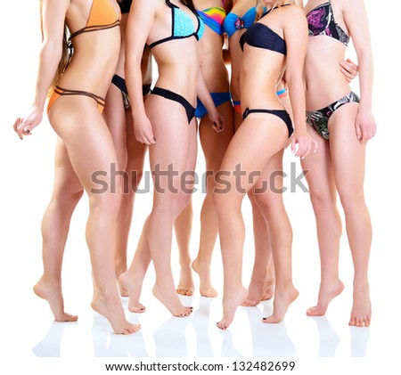 group of girls in bikini, seven attractive caucasian young women in swimsuits over white