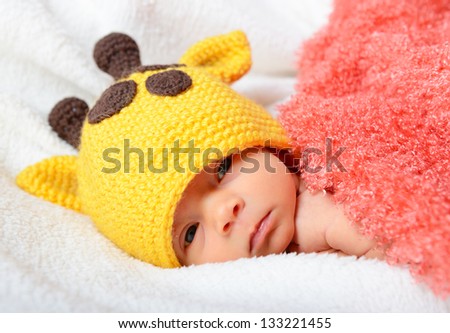 cute baby sleeping in funny  hat and smiling in sweet dreams, beautiful kid\'s face closeup