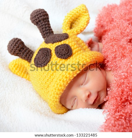 cute baby sleeping in  hat and smiling in sweet dreams, beautiful kid\'s face closeup
