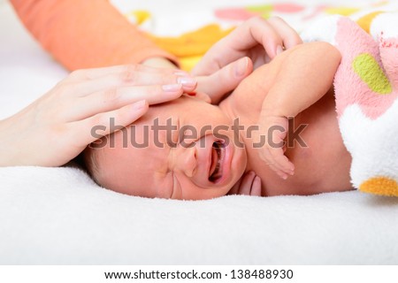 mothercare, young mother calms her newborn baby during she is crying and screaming