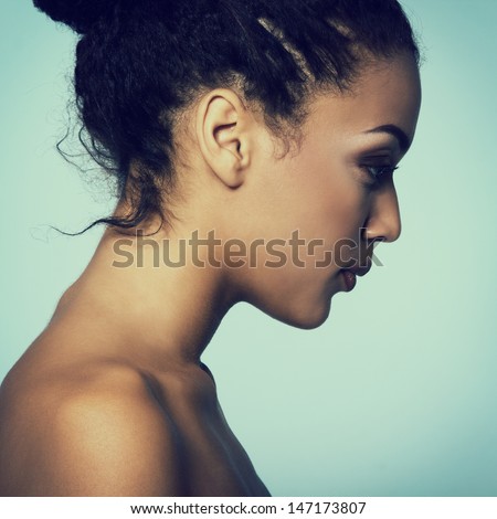 Beauty portrait of young mulatto fresh fashion woman in profile, toned