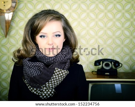 art portrait of young woman standing in room with vintage wallpaper and interior, retro stylization 60-70s