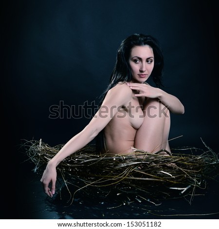 Young naked woman sitting in nest, image toned and noise added