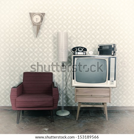 Vintage Room With Wallpaper, Old Fashioned Armchair, Retro Tv, Phone, Clocks, Radio Player And Standart Lamp. Image Toned, Noise Added And Vignetted