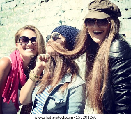 Girls having fun together outdoors and making moustache of hair lifestyle theme toned Girls having fun together outdoors and making moustache of hair lifestyle theme toned