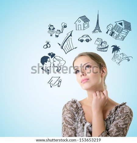 Portrait of dreaming girl looking up into the corner making future plans, over blue background with copyspace