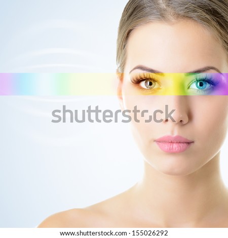 beautiful woman\'s face with rainbow light on eyes