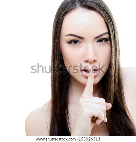 Portrait of attractive young woman with secret over white background