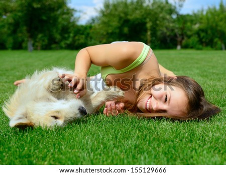 Beautiful Young Happy Laugh Girl Playing With Her Dog Outdoor