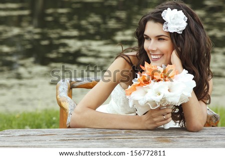 young woman with flowers summer outdoor, beautiful bride has fun in summer park