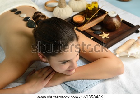 Young Beautiful Woman In Spa Environment Gets Massage With Hot Stones, Salon Stone-Therapy