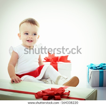 Holidays, baby girl with presents, christmas, birthday, new year, x-mas concept - happy child girl with gift boxes, toned