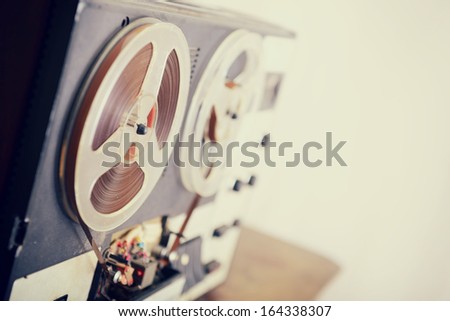 Old portable reel to reel tube tape-recorder, toned, with copyspace