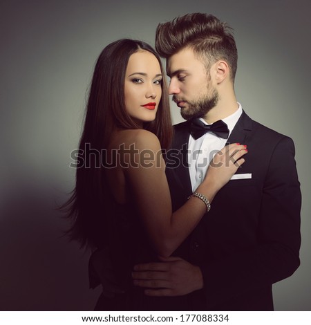 Sexy passion couple in love. Portrait of beautiful young man and woman dressed in classic clothes