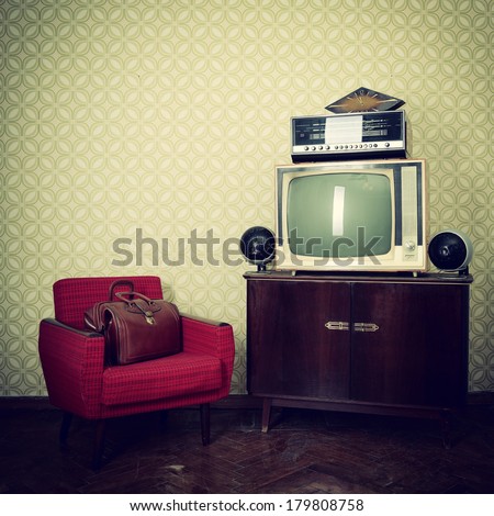Vintage room with wallpaper, old fashioned armchair, retro tv, bag, clocks, radio player and loudspeakers