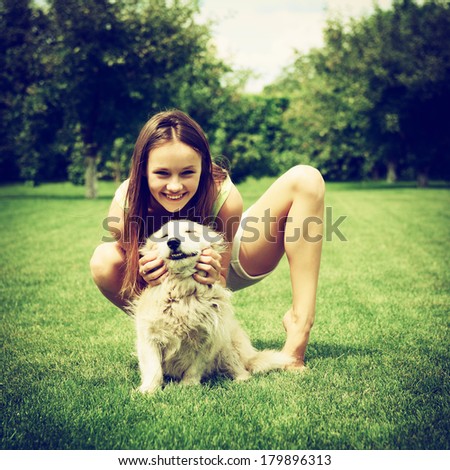 beautiful young happy laugh girl playing with her dog outdoor, instagram effect