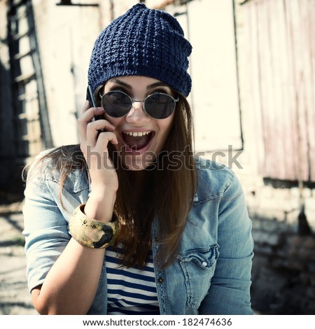A portrait of a smiling beautiful woman calling with her phone, toned