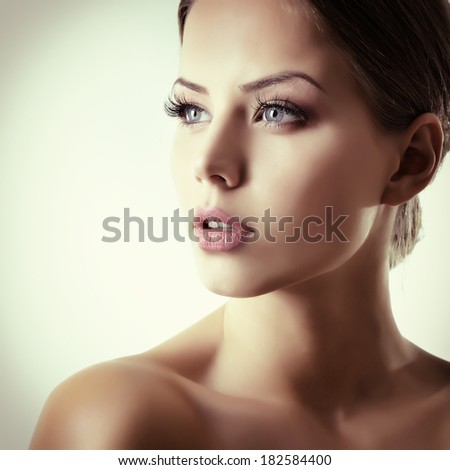Beauty portrait of young woman with beautiful healthy face, studio shot of attractive girl, toned