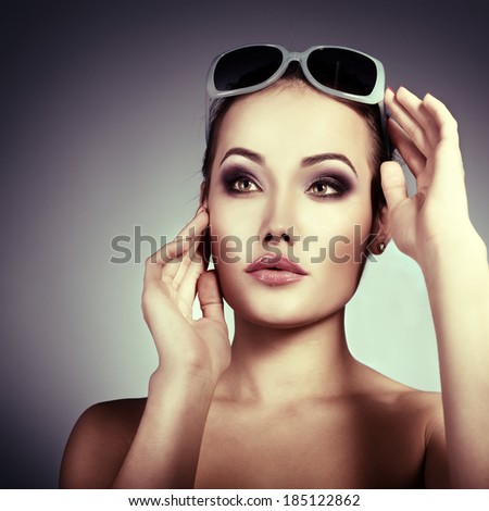 Beautiful girl with sun glasses. Sexy woman. Fashion girl. Image toned.