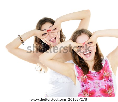 Portrait of a two teen girls have fun and make faces looking and searching something, isolated on white