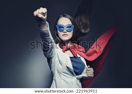 Young pretty woman opening her shirt like a superhero. Super girl, image toned. Beauty saves the world. Image toned.