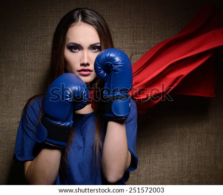 Young pretty woman opening her t-shirt like a superhero. Super girl, image toned. Beauty saves the world.
