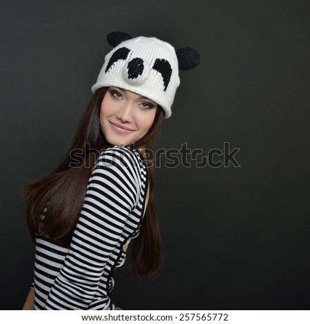 Glamour portrait of beautiful woman model with fresh daily makeup and funny hand made hat. Fashion female portrait.