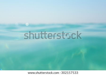 Clean turquoise sea wave close up. Natural sea beauty, soft focus.
