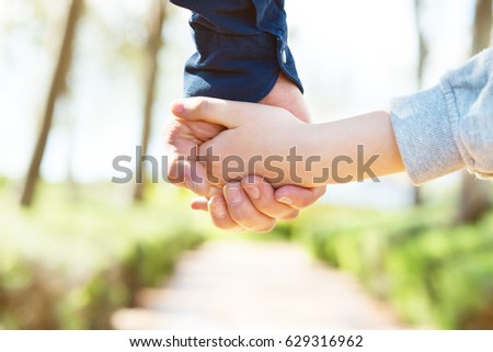 Road to life. Hands. Father\'s and his son hands. Dad leading son over summer nature outdoor. Male and children hands closep. Family, trust, protecting, care, parenting concept.