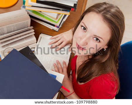 Young woman with lot of books. Reading a books.