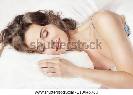 Closeup portrait of a young beautiful woman sleeping on the bed. Sweet dreams. Good night