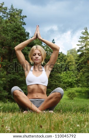 yoga woman on green park. Beautiful young woman doing yoga exercise. Outdoor sport