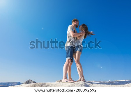 caressing couple under the hot summer sun and blue sky. Bright feelings and emotions