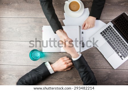 Handshake - Man and woman Hand holding. Top view for top managers