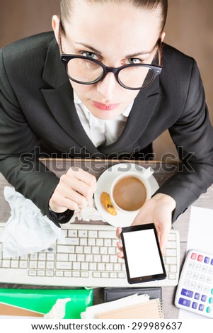 Office Coffee break on Workplace at the table. chatting mobile Phone. Girl with glasses office worker lunch. Desk untidy. White background on the monitor, you can place your information. Top view