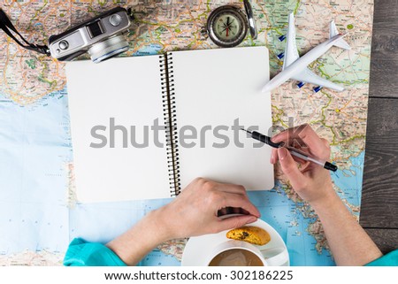 The woman blogger writing reviews about places visited in the trip. Planning travel. Thirst travel
