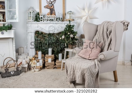 Interior room decorated in Christmas style. No people. An empty chair. Neutral colors. Home comfort of modern home. A series of photos